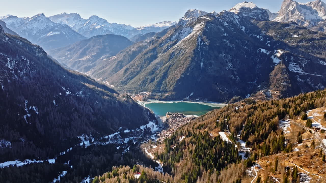 Aerial drone view of the Alleghe village with Lake Alleghe, in the province of Belluno, Dolomites, Italy