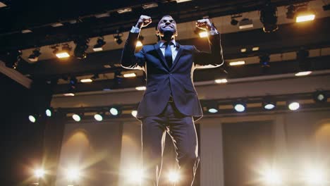 businessman celebrating success on stage