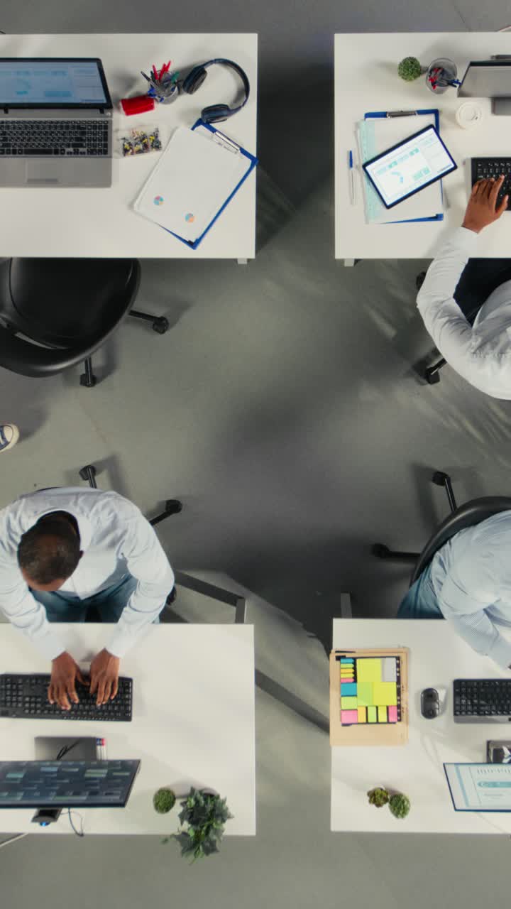 Vertical Video Top down view zoom out of coworkers broadcasting an advertising vlog