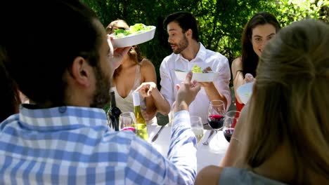 group of friends enjoying meal at outdoor lunch