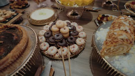 dessert table with assorted donuts and cakes at a festive event