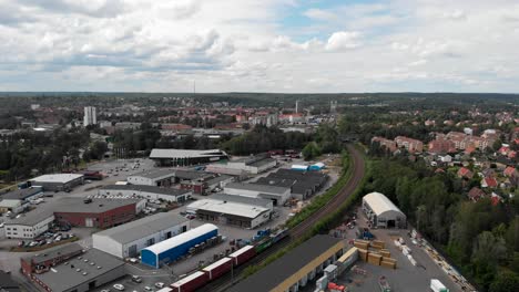 AERIAL---Freight-train-in-industrial-area-in-Trollhättan,-Sweden