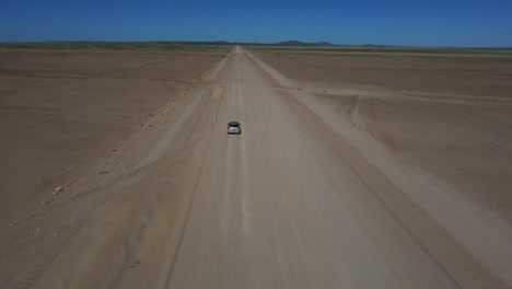 drone shot of the namib-naukluft national park in namibia - drone is following a car in the beautiful steppe area. snippet could ideally be used for travel or nature related movies or namibia videos.