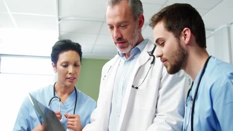 three doctors studying a x-ray