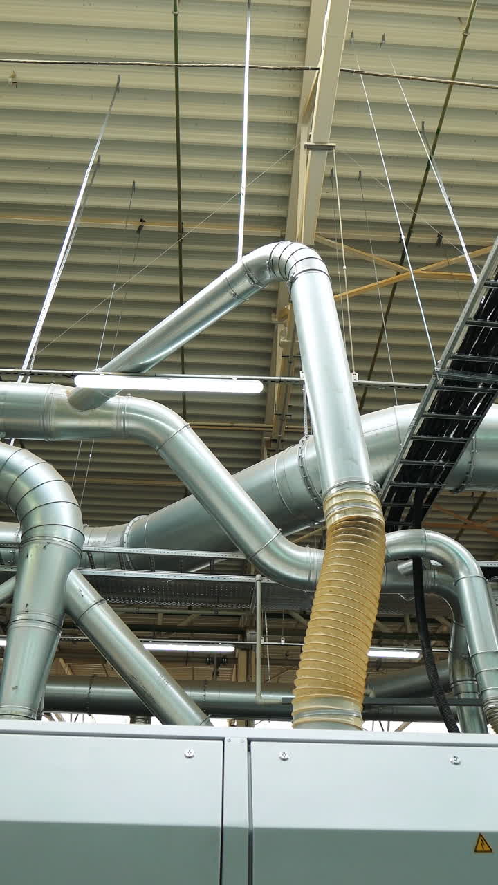 modern branch of the ventilation system inside the floorboard manufacturing plant. Innovative technology of woodworking plant. Vertical video