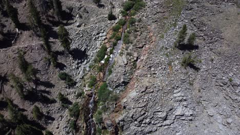 overhead shot of a waterfall trickling down the rocks on a mountain