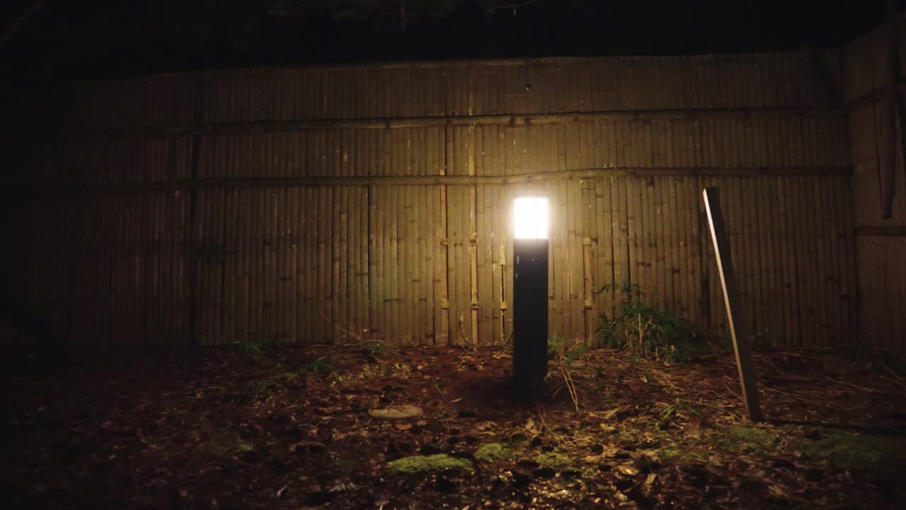 Bamboo Fence at Ryokan Bath House at Night, Snow Falling in Winter Japan