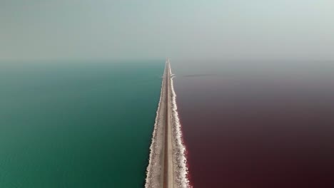 awesome aerial from pink and blue lake over the great salt lake in utah