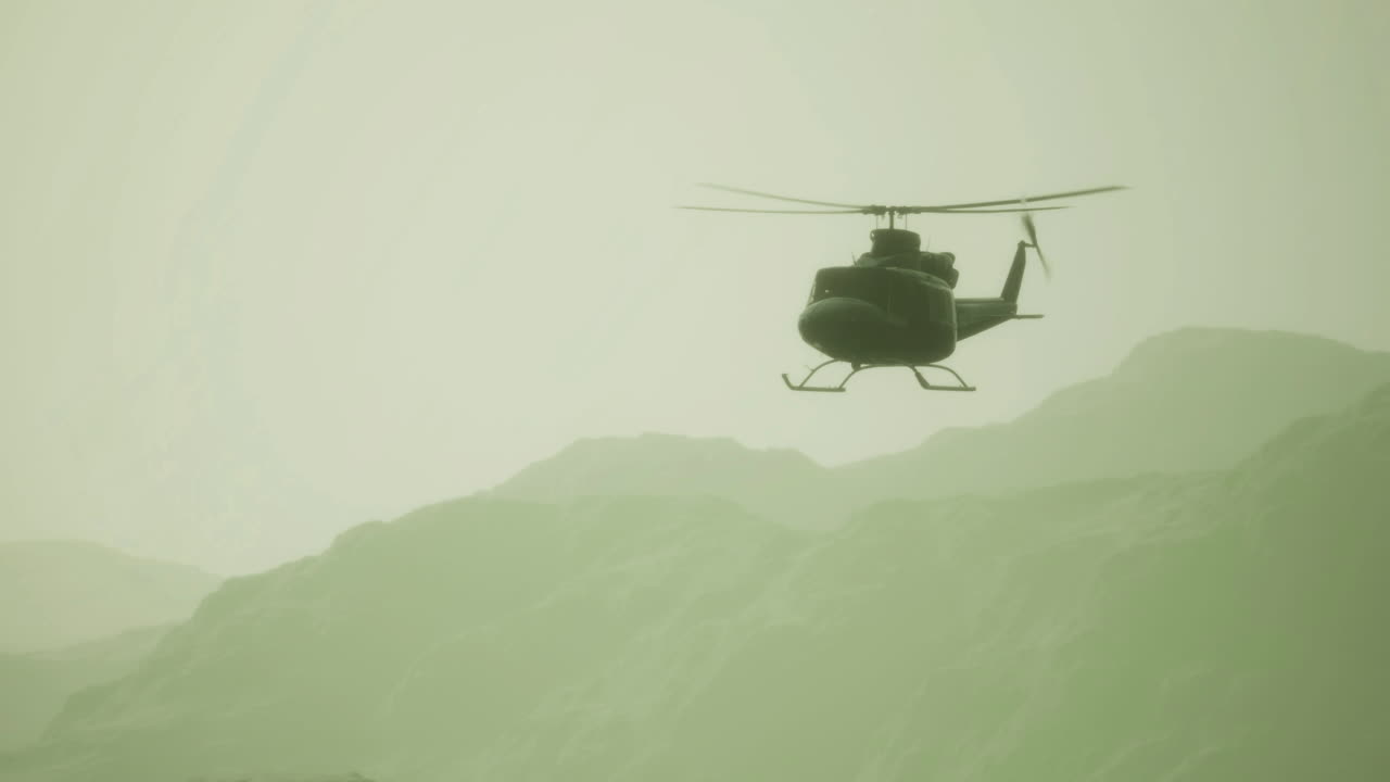 Helicopter flying over misty mountains during early morning light