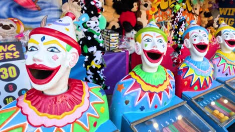 colorful clowns at a carnival game booth