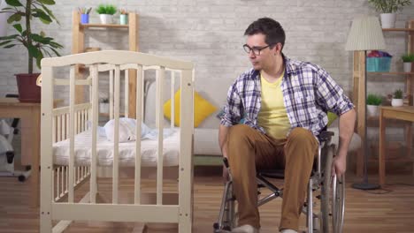 a disabled man in a wheelchair a young father in a children's bedroom