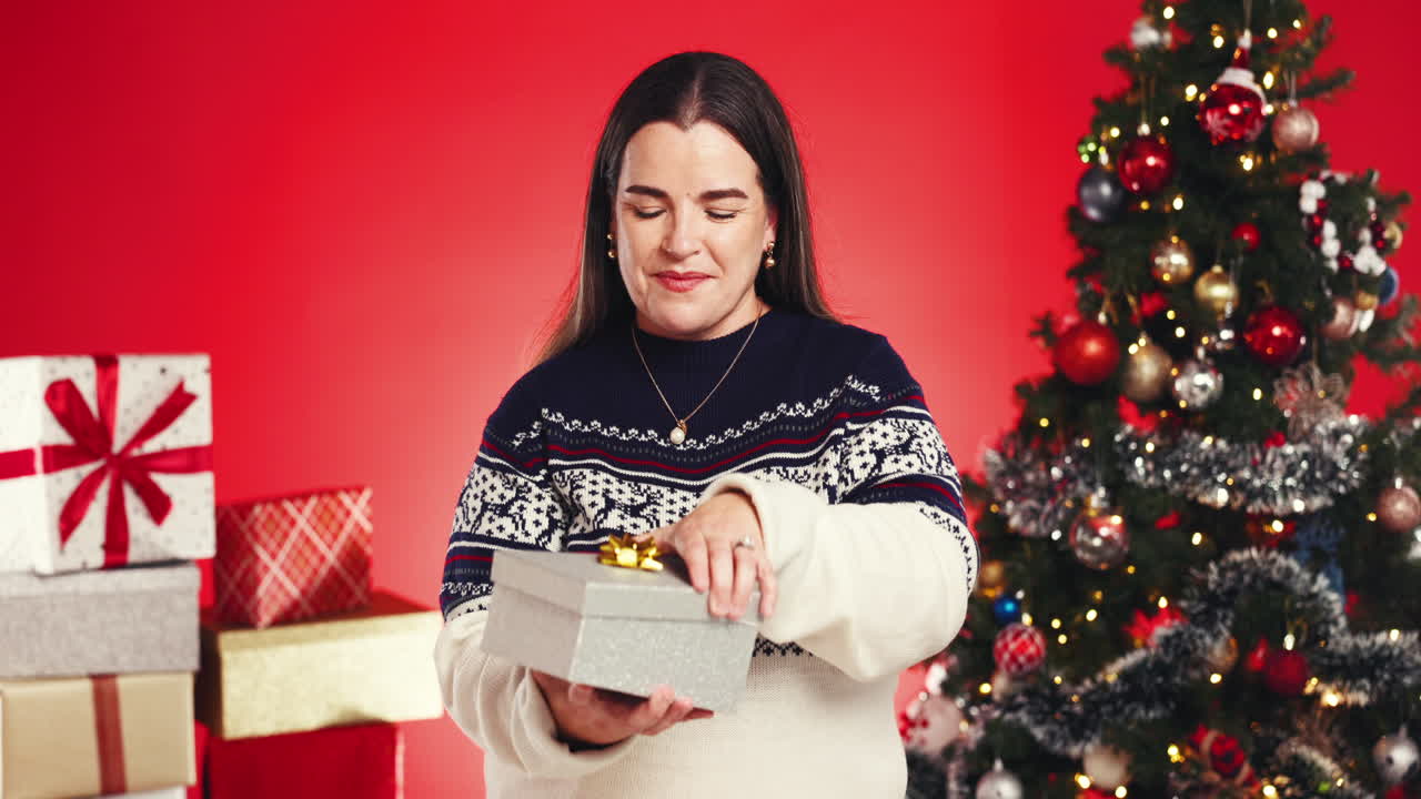 Woman opening Christmas presents
