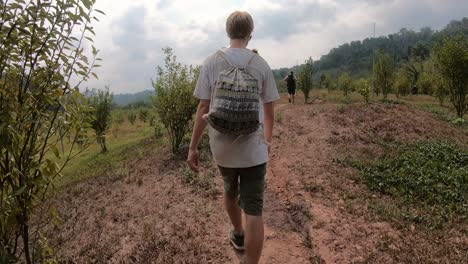 Multiple-Young-Males-Hiking-in-the-Fields-of-Laos-during-the-Gibbon-Experience-showing-bushes-of-Fruit