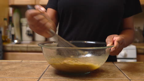 using a whisk to stir together ingredients for a special homemade dessert