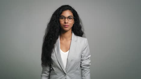 Portrait-of-a-smiling-beautiful-young-businesswoman-in-studio-shot