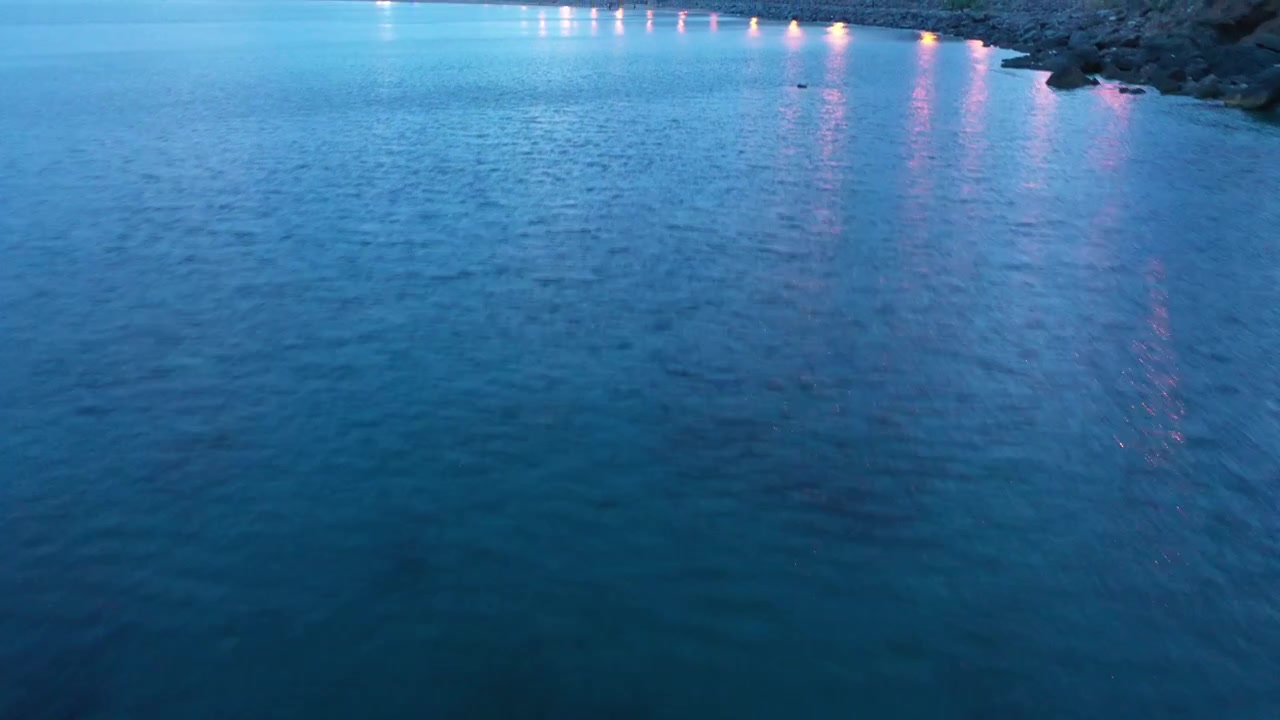 Close aerial view of calm blue Mediterranean seawater in Northern Morocco, showing subtle ripples, soft reflections and natural water texture suitable for marine backgrounds and travel footage.