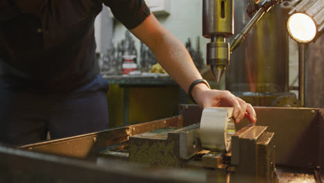 Caucasian-male-hands-factory-worker-at-a-factory-standing-at-a-workbench-and-operating-a-machinery