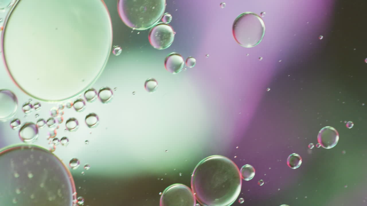 Animation of bubbles moving on green and pink background with copy space