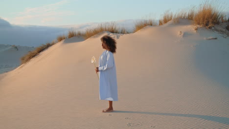 woman standing desert flower at summer. african american girl posing with calla.