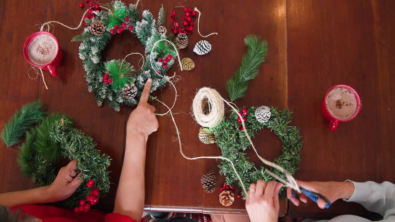 Crafting Christmas wreaths together, enjoying hot cocoa and festive decorations