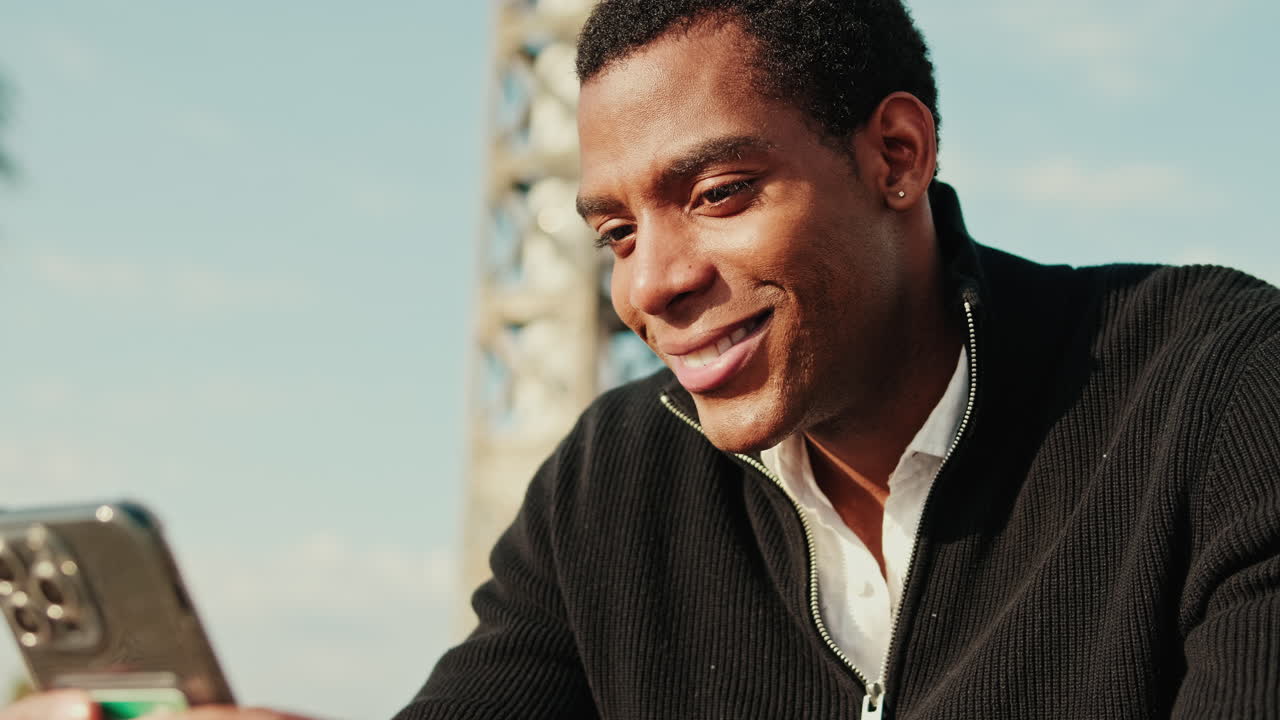 Smiling African American Man Using Smartphone Outdoors
