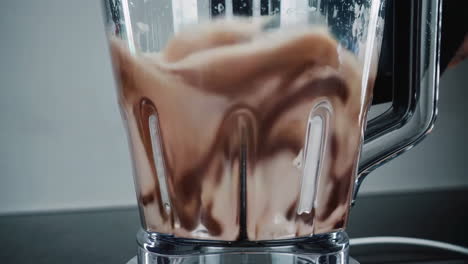 making a chocolate milkshake in a blender