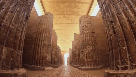low angle pov, walking through djoser colonnade pillars in egypt