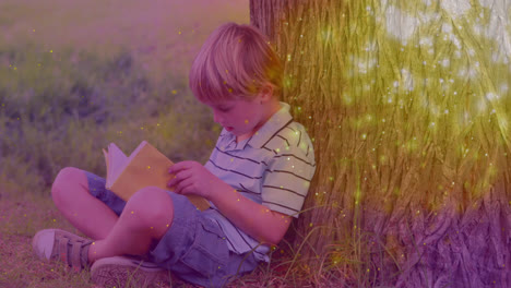 animación de manchas brillantes sobre un niño caucásico leyendo un libro