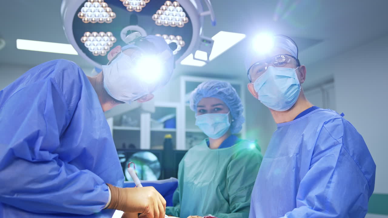 Surgeons focused during complex neurosurgical procedure. Surgeons focused during a complex neurosurgical procedure in the operating theater