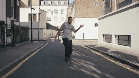 Contemporary-funky-mixed-race-man-street-dancer-dancing-freestyle-in-the-city