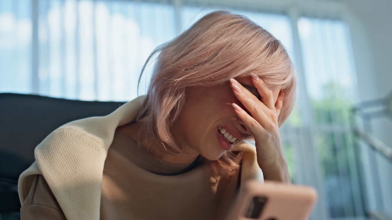 Businesswoman hand taking mobile phone reacting fail alone in office closeup