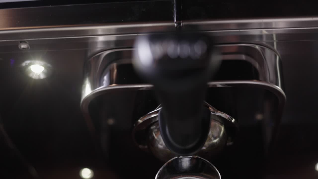 Fresh espresso flowing into small espresso cans, Italian fresh roasted coffee, barista coffee machine, preparation for a milk coffee variation