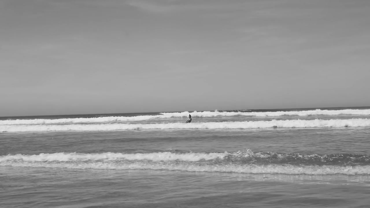 Black and White View of a Surfer Waiting in the Ocean