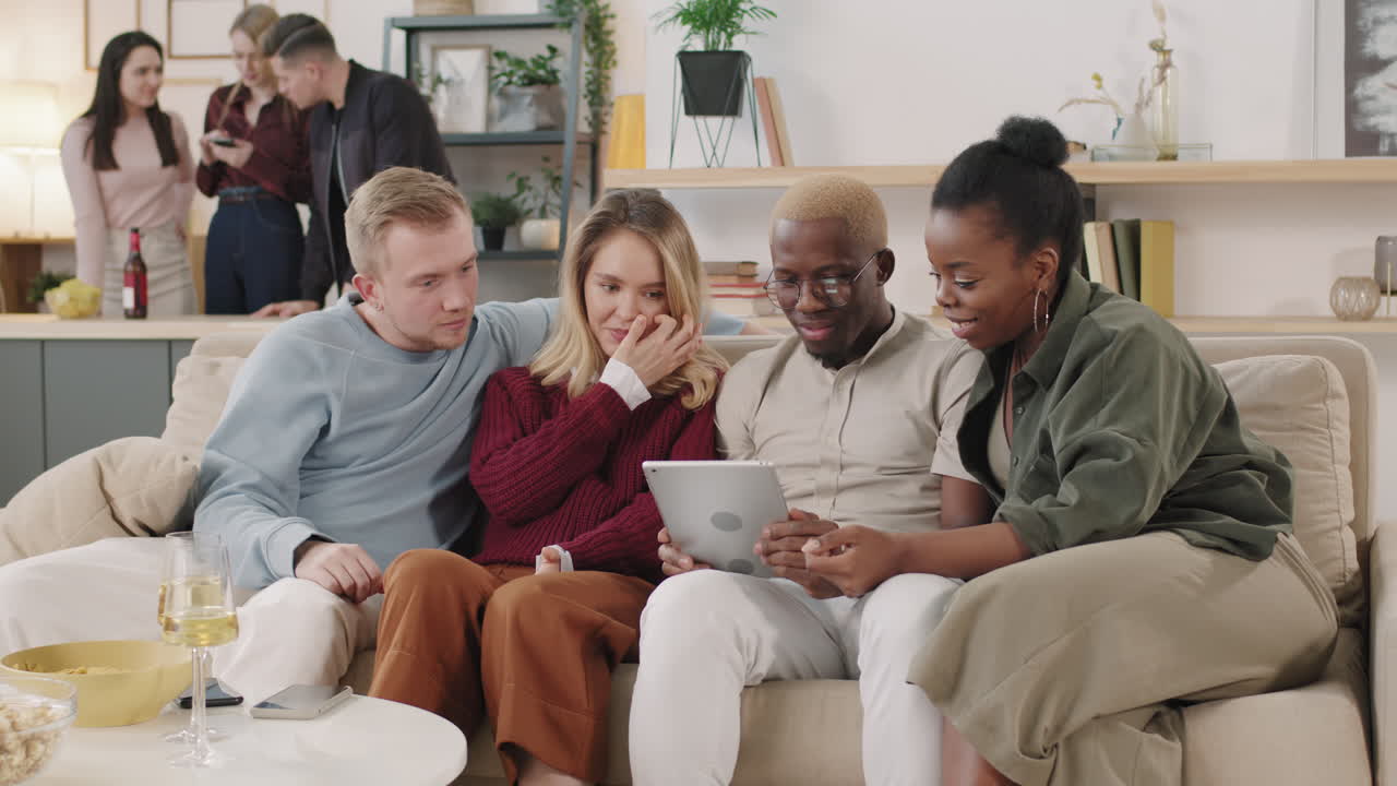 Group of Friends Looking at Tablet and Talking