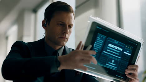 man using a futuristic transparent tablet with a digital interface