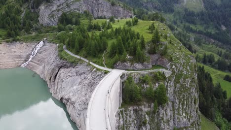 bird's-eye view of the large dam of the green lac de tseuzier in the swiss alps