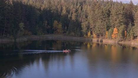 Lake-Adventures:-A-Small-Fishing-Boat-in-Action,-Hooking-Fish-in-the-Serene-Waters