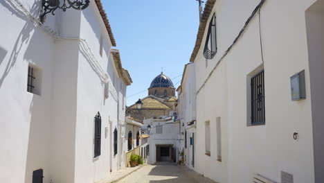 whitewashed streets and a church dome in a spanish village