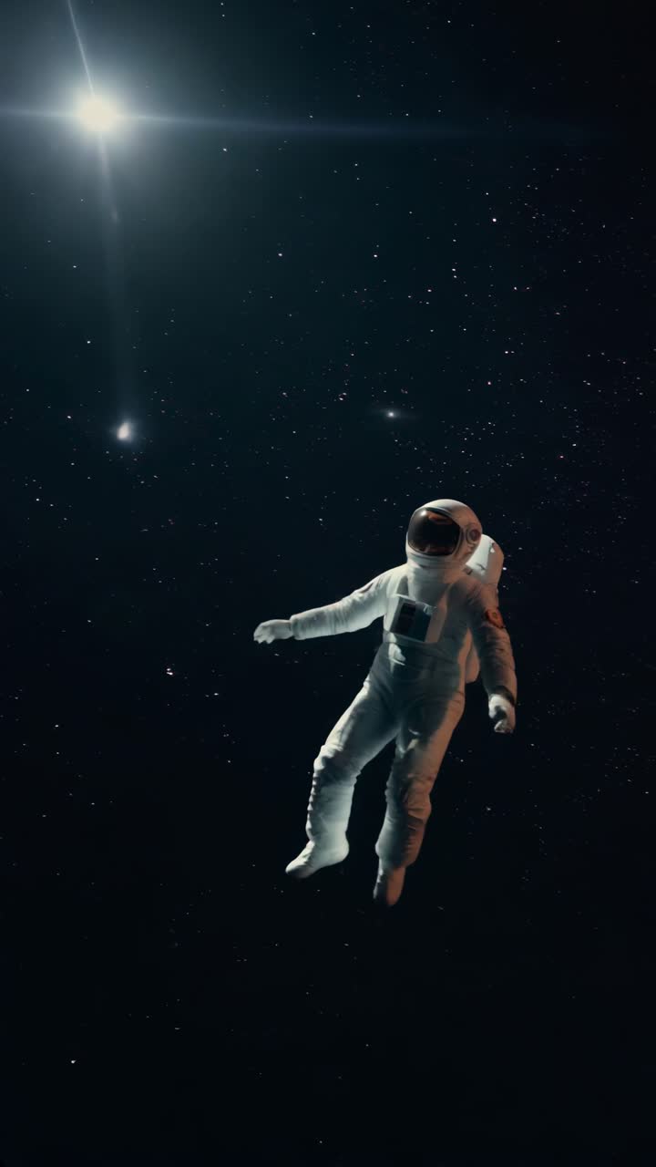 A lone astronaut floats in space, captured from a low-angle shot