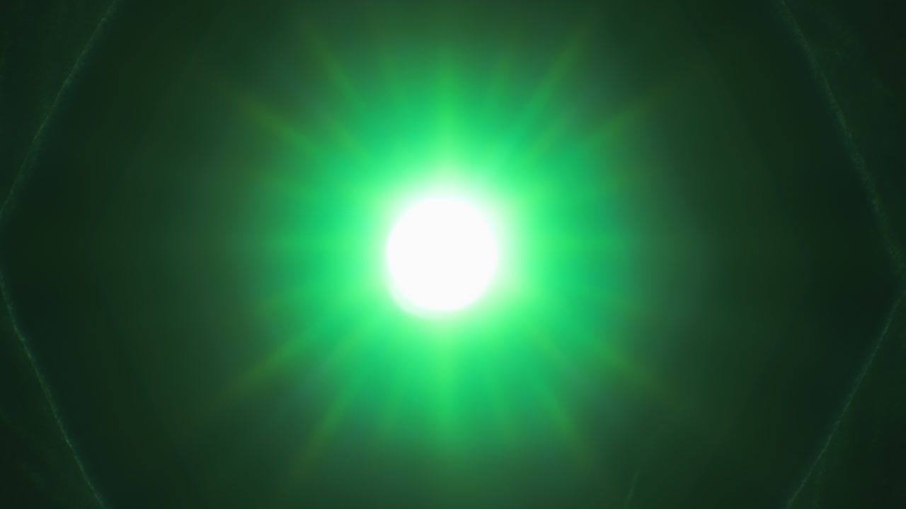 Green light rays shining through old camera lens, while diaphragm blades are opening