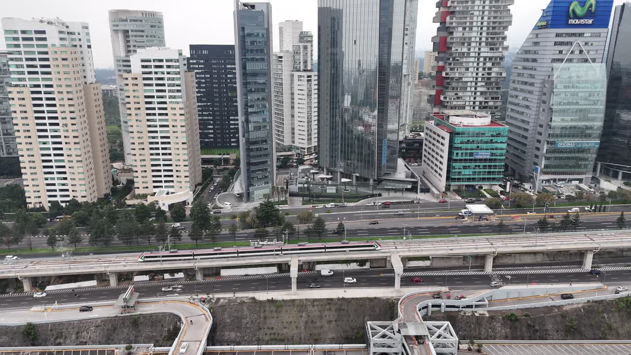 shot of train passing through santa fe corporatives buildings in mexico city at morning