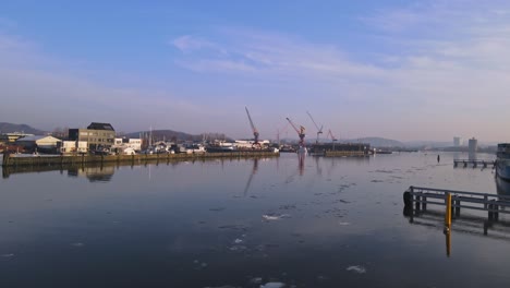 gota alv river with harbour cranes and buildings in the background in gothenburg, sweden