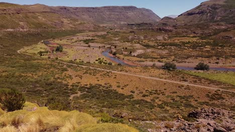 aerial view in mountain valley next to river in patagonia, argentina