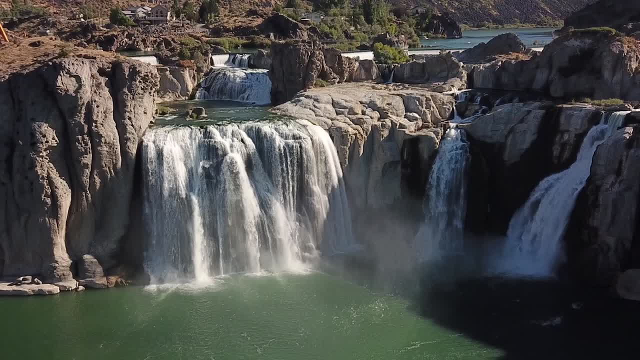 Aerial cinemagraph of huge waterfall flowing into a reservoir