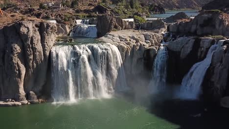 Aerial cinemagraph of huge waterfall flowing into a reservoir