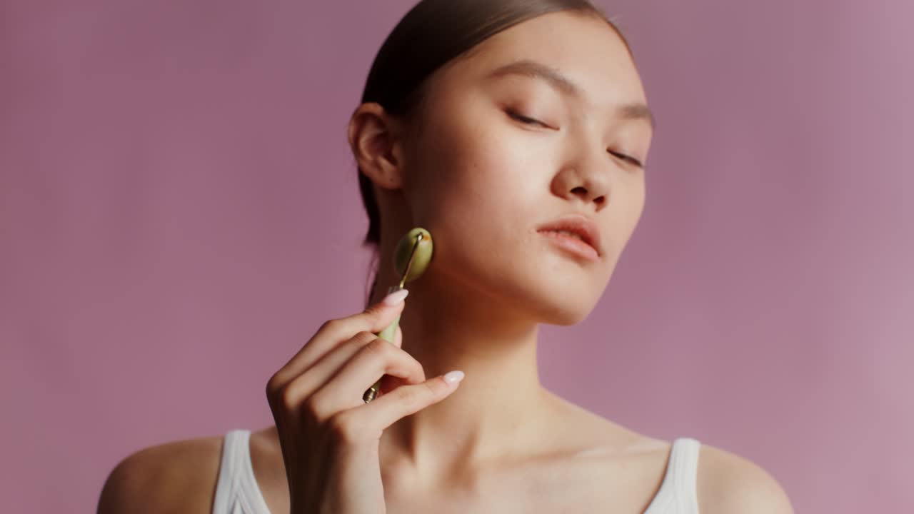 Woman using jade roller for skincare