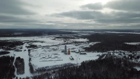 oil and gold mine in wintery canada in the middle of the forest - drone 4k aerial