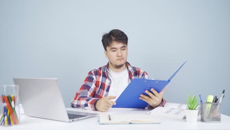 the man examining the files approves the files with his head.