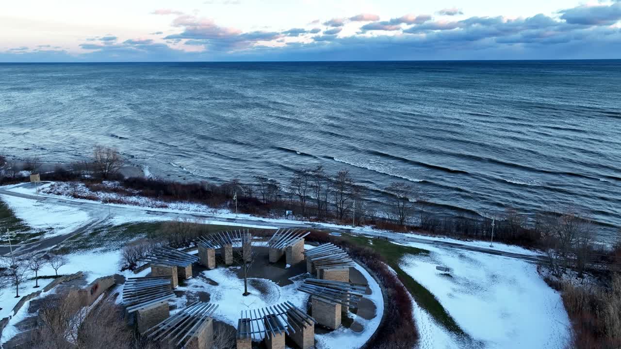 Luftfoto fra drone nær Ajax Vandforsyningsanlæg og kystmonument under den blå time om vinteren.