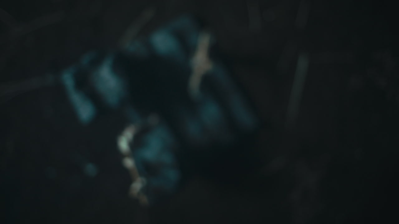 Miniature mummified dolls hanging on the gallows at night